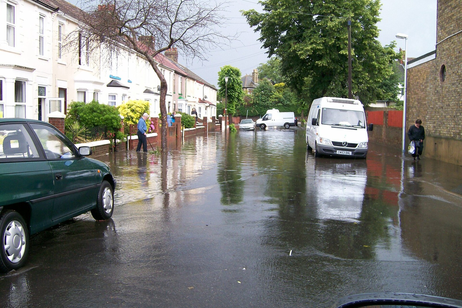 Residential street with standing floodwater after heavy rain — flood and specialty coverage